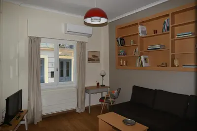 a living room with a couch and a window at Miranda's Apartment in Thissio in Athens