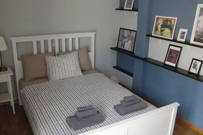 a bedroom with a bed with two towels on it at Illisia Roof Apartment in Athens