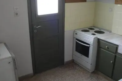 a small kitchen with a stove and a window at Illisia Roof Apartment in Athens