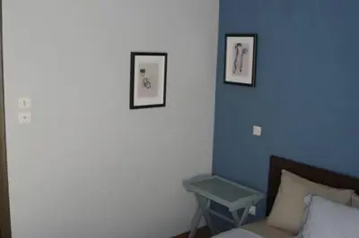 a bedroom with two pictures on the wall and a bed at Illisia Roof Apartment in Athens