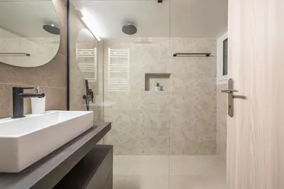 a bathroom with a white sink and a shower at Sofihome Ampelokipi Station in Athens