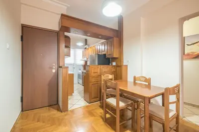 a kitchen and dining room with a table and chairs at Sofihome Ampelokipi Station in Athens
