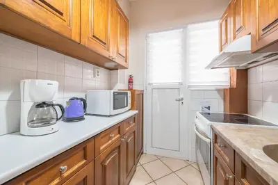 a kitchen with a coffee maker and a microwave at Sofihome Ampelokipi Station in Athens