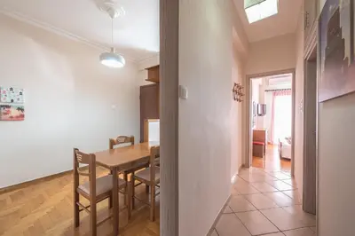 a kitchen and dining room with a table and chairs at Sofihome Ampelokipi Station in Athens