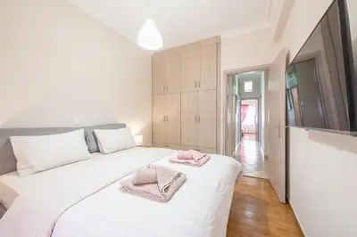 a bedroom with a white bed with towels on it at Sofihome Ampelokipi Station in Athens