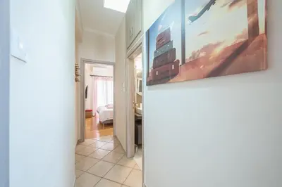 a hallway with a painting hanging on a wall at Sofihome Ampelokipi Station in Athens