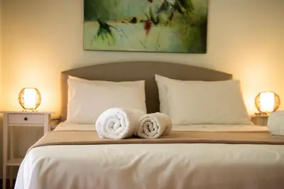 a bedroom with a bed with towels on it at Blue Ark Athenian Nest in Athens