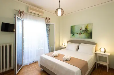 a bedroom with a bed with two towels on it at Blue Ark Athenian Nest in Athens