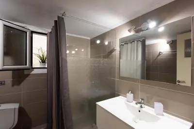 a bathroom with a sink and a shower at Blue Ark Athenian Nest in Athens