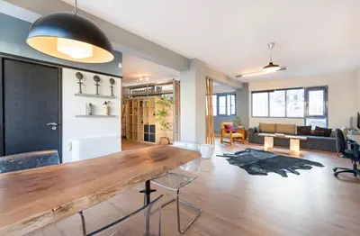 a living room with a wooden table and a couch at Comfort Stay Lofts in Athens