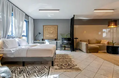 a bedroom with a bed and a living room at Comfort Stay Lofts in Athens
