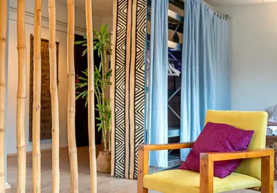 a yellow chair with a purple pillow in a room at Comfort Stay Lofts in Athens
