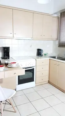 a kitchen with white cabinets and a white oven at Errathens Wheat Apartment - Athens Center, 3 BD, 1 BATH in Athens