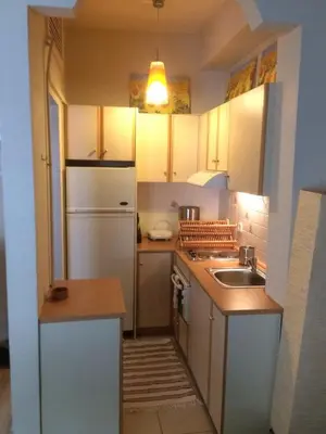 a kitchen with a white refrigerator and a sink at Flat31 in Athens