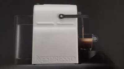 a small espresso machine with a glass of coffee at Flat31 in Athens