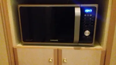 a microwave sitting on top of a cabinet at Flat31 in Athens