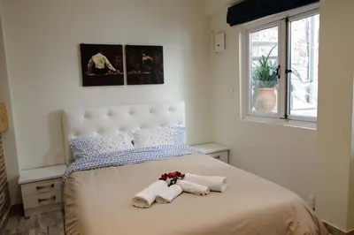 a bedroom with a bed with towels and a window at George Studio in Athens
