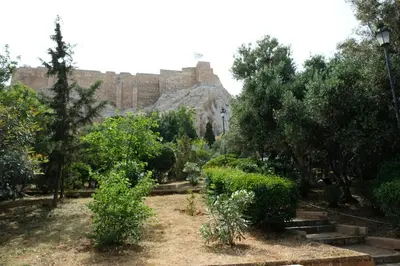 a garden with trees and a castle in the background at George Studio in Athens