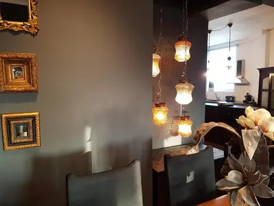 a dining room with chandeliers and a table with chairs at ADMETUS PSYRRI LOFT by K&K in Athens