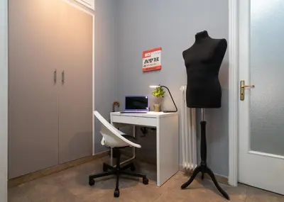 a mannequin standing next to a desk with a laptop computer at Acropolis Apartment with a unique view in Athens