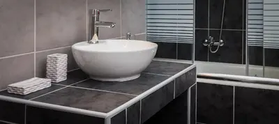 a bathroom with a white bowl sink on a counter at Acropolis Apartment with a unique view in Athens