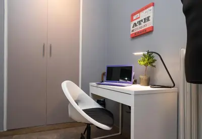 a white desk with a laptop and a chair at Acropolis Apartment with a unique view in Athens
