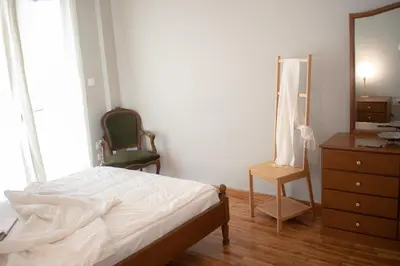 a bedroom with a bed and a dresser and a mirror at Apartment Vresthenis in Athens