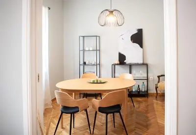 a dining room with a wooden table and chairs at Apartment Vresthenis in Athens