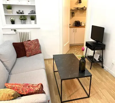 a living room with a couch and a table at Artistic Deco Apartment in Athens