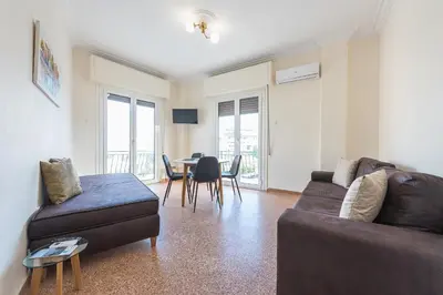 a living room with a couch and a table at Super Paradise Apartments in Athens