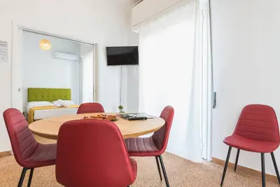 a room with a table and chairs and a bed at Super Paradise Apartments in Athens