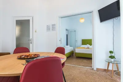 a room with a table and chairs and a bedroom at Super Paradise Apartments in Athens