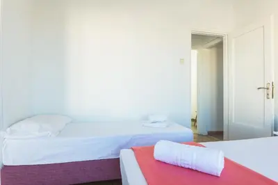 a hotel room with two beds and a red towel at Super Paradise Apartments in Athens