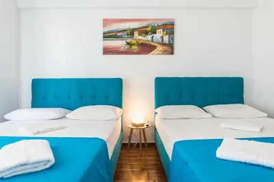 two beds sitting next to each other in a room at Super Paradise Apartments in Athens