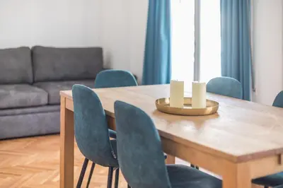a dining room table with chairs and a couch at Victoria Sun Apartments in Athens