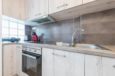 a kitchen with a sink and a counter top at Victoria Sun Apartments in Athens