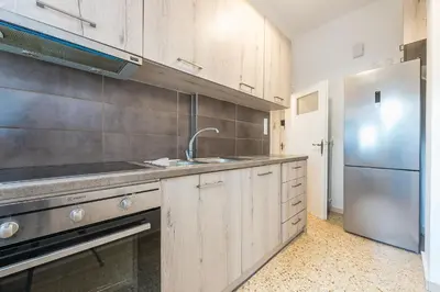 a kitchen with a sink and a refrigerator at Victoria Sun Apartments in Athens