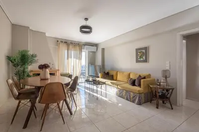 a living room with a couch and a table at Renovated 3 bedroom apt with Acropolis View in Athens