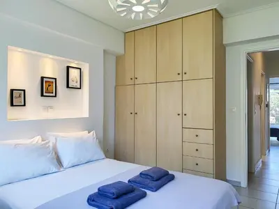 a bedroom with a bed with two towels on it at KYMA Apartments - Athens Acropolis 13 in Athens