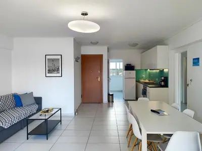 a living room with a couch and a table and a kitchen at KYMA Apartments - Athens Acropolis 13 in Athens