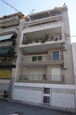 an apartment building with white doors and a balcony at KYMA Apartments - Athens Acropolis 13 in Athens