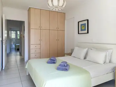 a bedroom with two beds with towels on them at KYMA Apartments - Athens Acropolis 13 in Athens