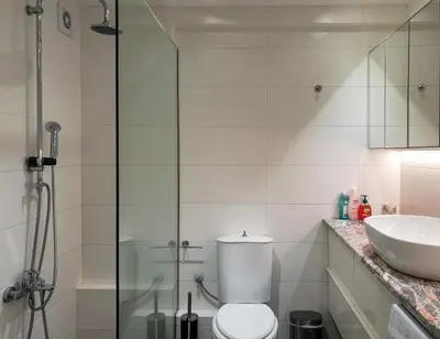 a bathroom with a shower and a toilet and a sink at KYMA Apartments - Athens Acropolis 13 in Athens