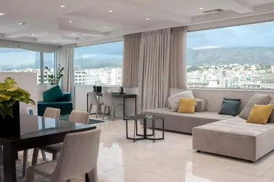 a living room with a couch and a table at Athenaeum Grand Hotel in Athens