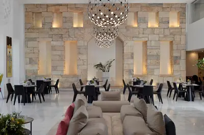 a lobby with a couch and tables and chairs at Athenaeum Grand Hotel in Athens