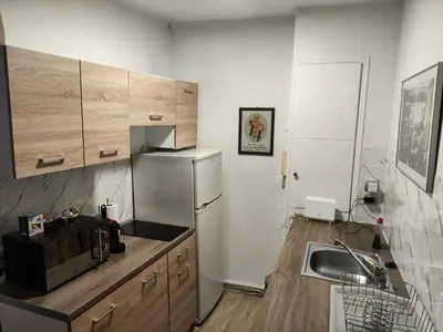 a kitchen with a sink and a refrigerator at Ulysses Apartments Monastiraki in Athens