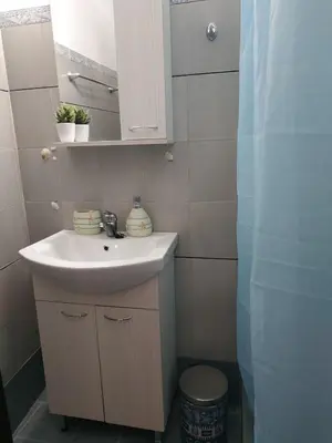 a bathroom with a sink and a mirror at Παραθαλασσια στουντιο Μιχαλιας Sea view studio Michalias in Agia Marina Aegina