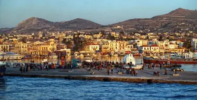 a group of people walking on a dock near the water at Παραθαλασσια στουντιο Μιχαλιας Sea view studio Michalias in Agia Marina Aegina