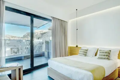 a bedroom with a bed and a large window at Athens Lodge by Athens Prime Hotels in Athens