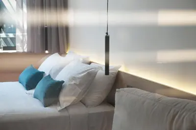 a bed with pillows on it in a room at Athens Lodge by Athens Prime Hotels in Athens